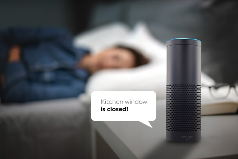 Woman sleeping in bed with Amazon Alexa next to her on table